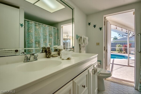 bathroom featuring tile patterned floors, vanity, and toilet