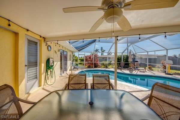 view of pool with a patio and glass enclosure