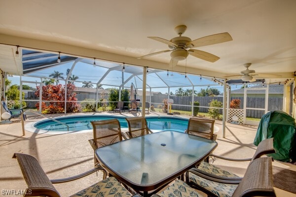 view of pool with a lanai, a patio area, and ceiling fan