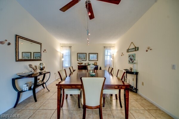 tiled dining space with ceiling fan