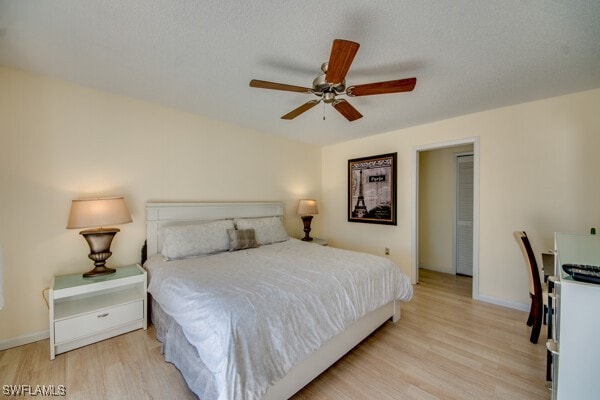 bedroom with ceiling fan and light hardwood / wood-style floors