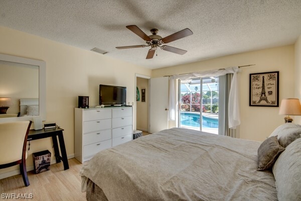 bedroom with ceiling fan, light hardwood / wood-style floors, access to exterior, and a textured ceiling