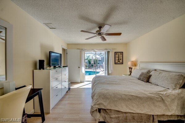 bedroom with a textured ceiling, access to outside, ceiling fan, and light hardwood / wood-style floors