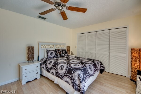 bedroom featuring a closet, ceiling fan, and light hardwood / wood-style flooring