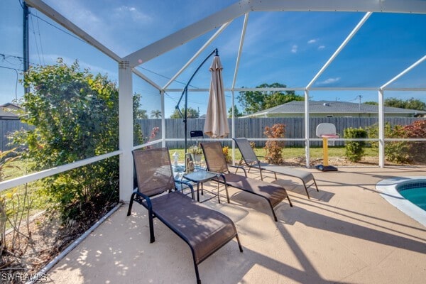 view of patio with glass enclosure