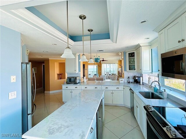 kitchen featuring pendant lighting, a healthy amount of sunlight, sink, and stainless steel appliances