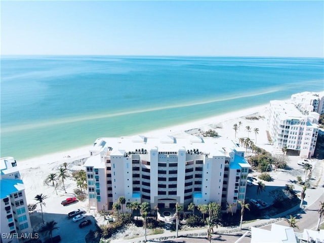 drone / aerial view featuring a water view and a view of the beach