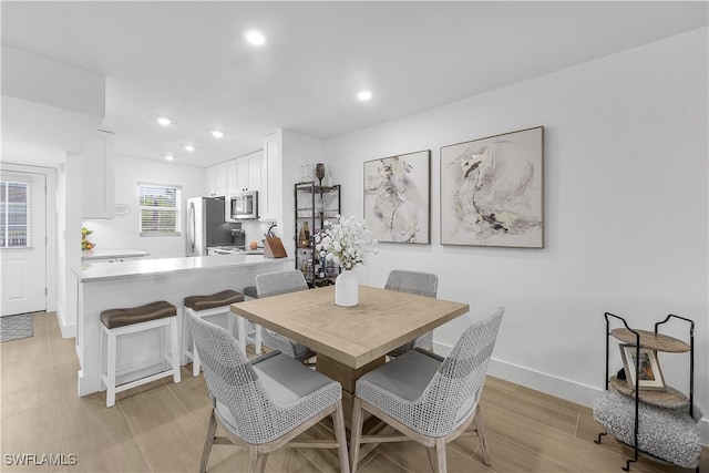 dining space with light wood-type flooring