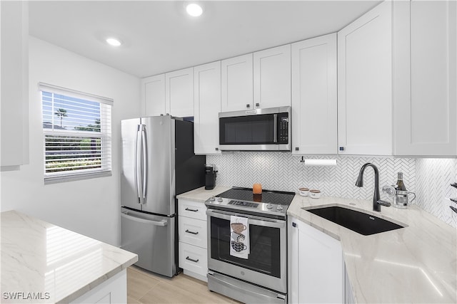 kitchen featuring white cabinetry, sink, and stainless steel appliances