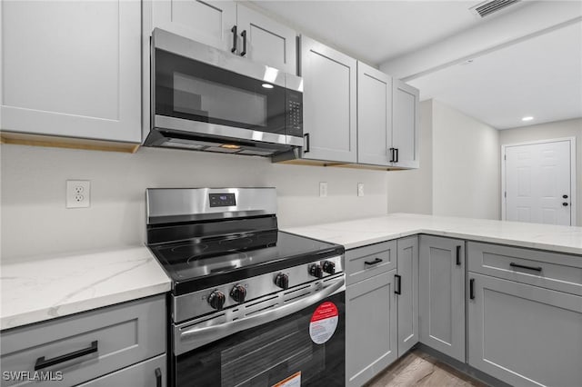 kitchen featuring gray cabinets and stainless steel appliances