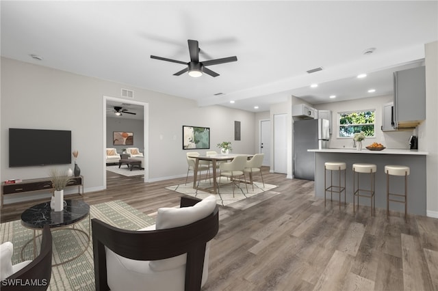 living room featuring ceiling fan and light wood-type flooring