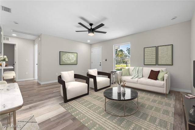 living room with light wood-type flooring and ceiling fan