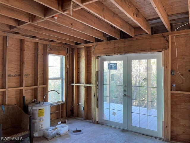 miscellaneous room with french doors, electric water heater, and plenty of natural light