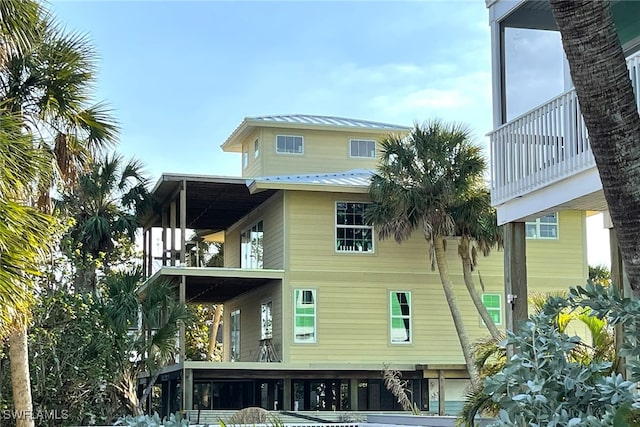 back of property featuring a balcony