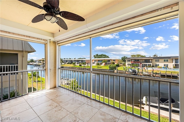 909 SE 46th Ln Unit 207, Cape Coral, FL 33904 - balcony with a water view, ceiling fan, and a residential view