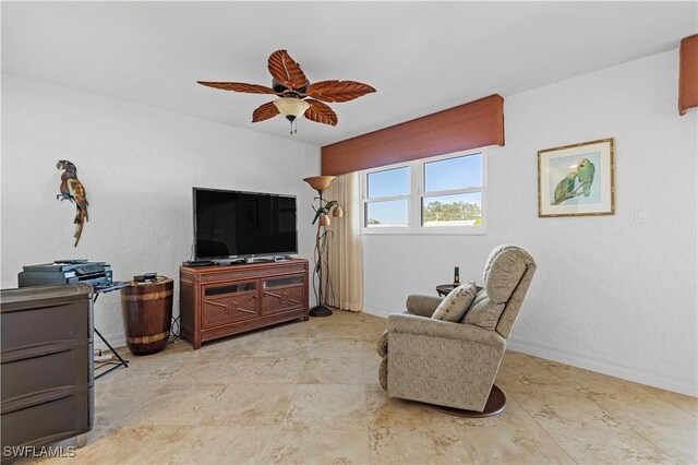 living area with ceiling fan