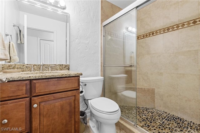 909 SE 46th Ln Unit 207, Cape Coral, FL 33904 - full bath featuring a textured wall, a stall shower, toilet, and vanity