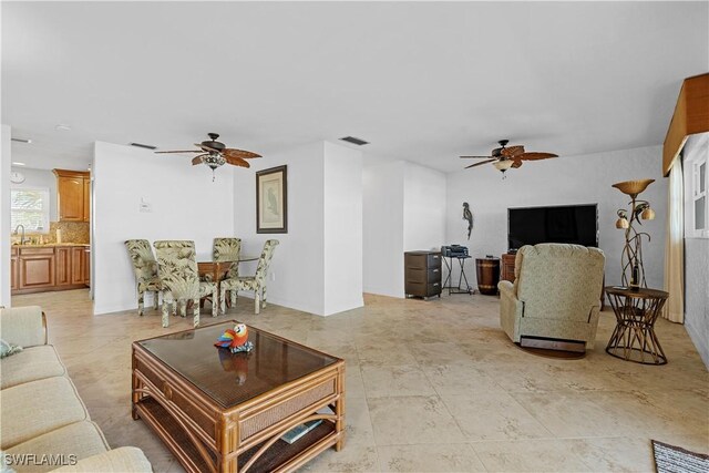 living room with ceiling fan and sink