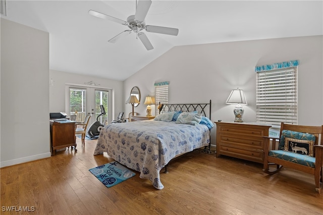 bedroom with ceiling fan, french doors, light hardwood / wood-style floors, and vaulted ceiling