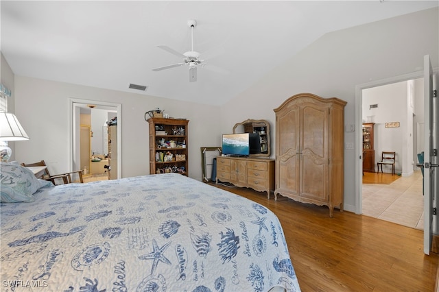 bedroom with ceiling fan, vaulted ceiling, and light hardwood / wood-style flooring