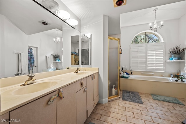 bathroom with plus walk in shower, an inviting chandelier, tile patterned floors, vaulted ceiling, and vanity