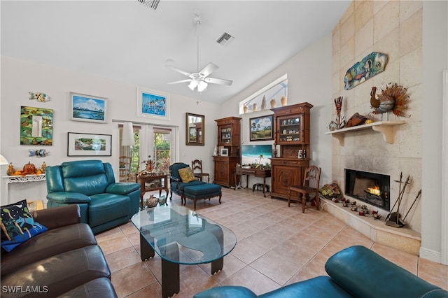 tiled living room with a tile fireplace, ceiling fan, french doors, and high vaulted ceiling