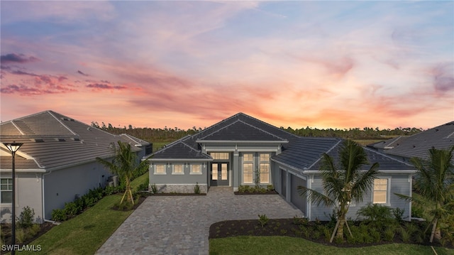 view of front of property featuring a garage and a yard