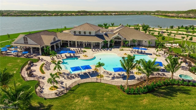 view of pool with a patio and a water view