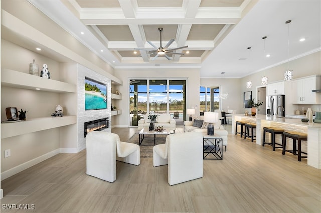 living room featuring a high ceiling, coffered ceiling, a fireplace, ornamental molding, and beamed ceiling