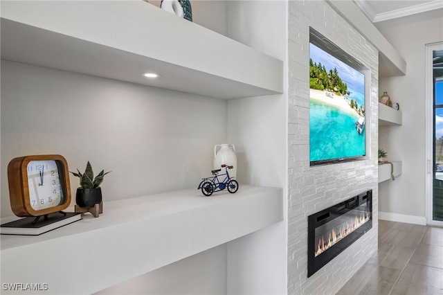 interior space featuring crown molding and a stone fireplace