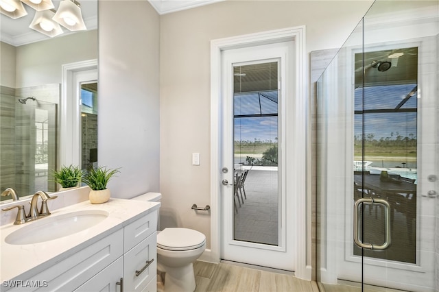 bathroom with an enclosed shower, hardwood / wood-style floors, vanity, and toilet