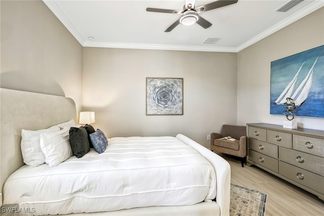 bedroom featuring ceiling fan, ornamental molding, and light hardwood / wood-style floors