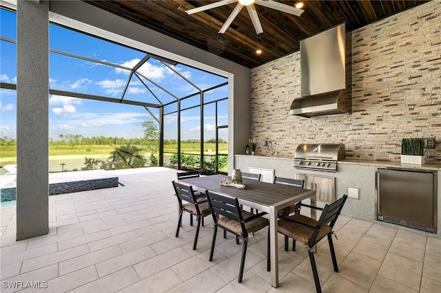 view of patio / terrace with an outdoor kitchen, area for grilling, and a lanai