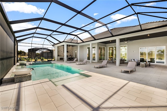 view of swimming pool with ceiling fan, a patio area, and glass enclosure