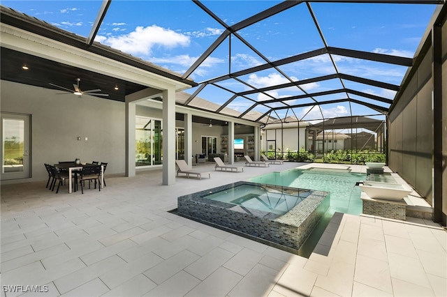 view of swimming pool featuring an in ground hot tub, a lanai, ceiling fan, and a patio area