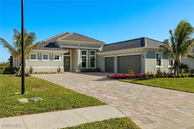 view of front of property featuring a garage and a front yard