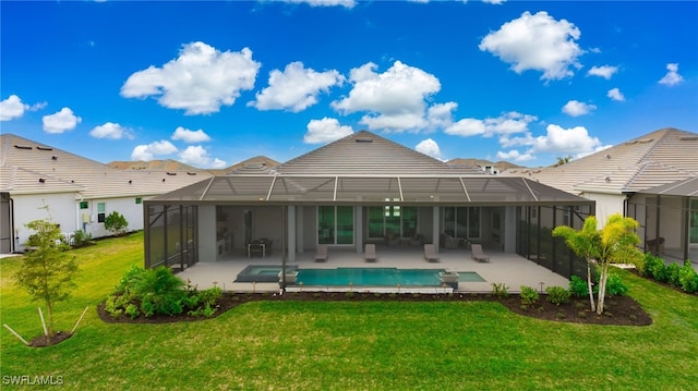 rear view of house featuring a patio, a yard, and glass enclosure