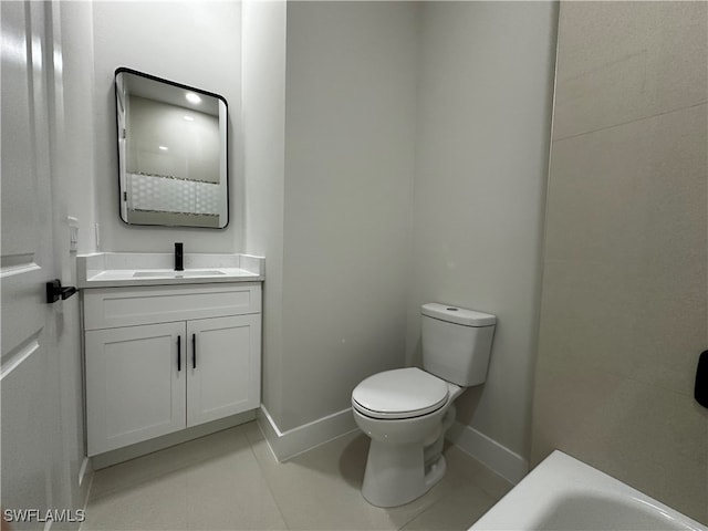 bathroom with tile patterned floors, vanity, and toilet