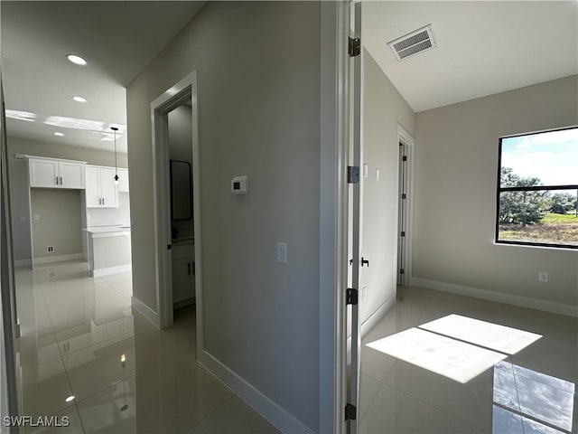 corridor with light tile patterned floors