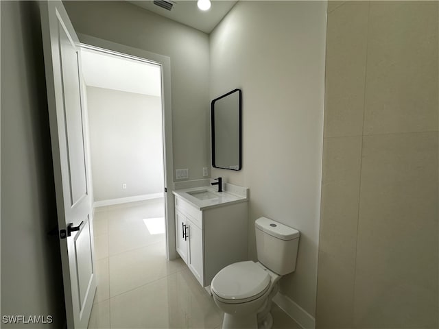 bathroom with tile patterned floors, vanity, and toilet