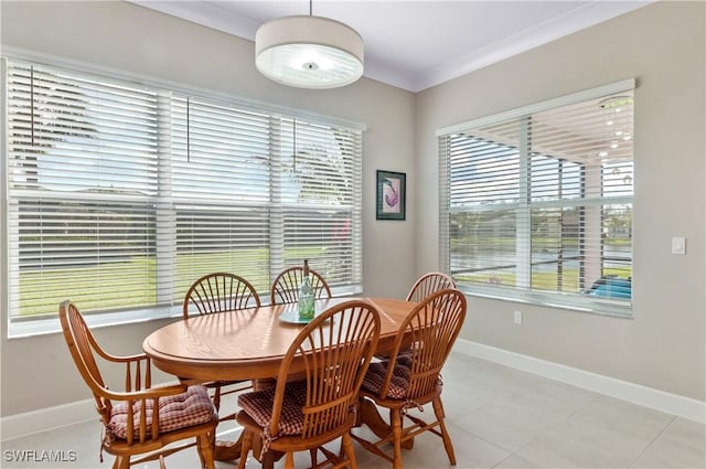 dining space featuring plenty of natural light, light tile patterned floors, and crown molding