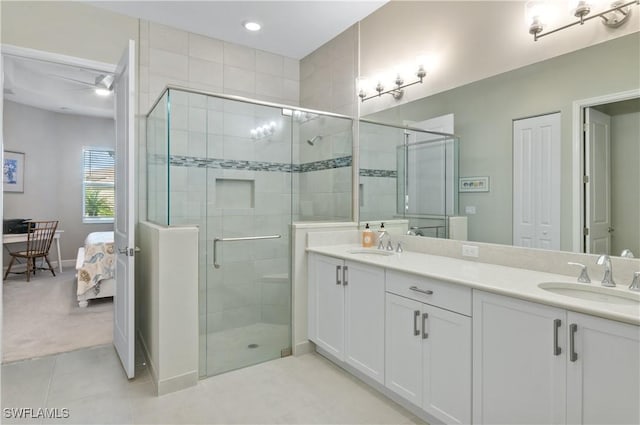 bathroom with tile patterned flooring, vanity, and walk in shower