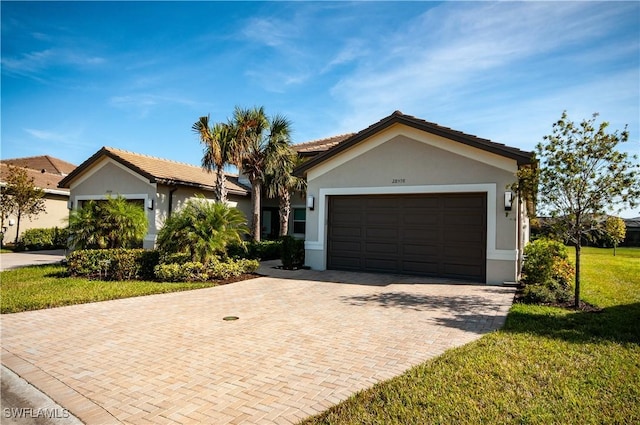 view of front of home with a garage and a front lawn