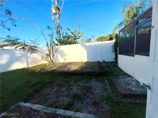 view of yard featuring glass enclosure