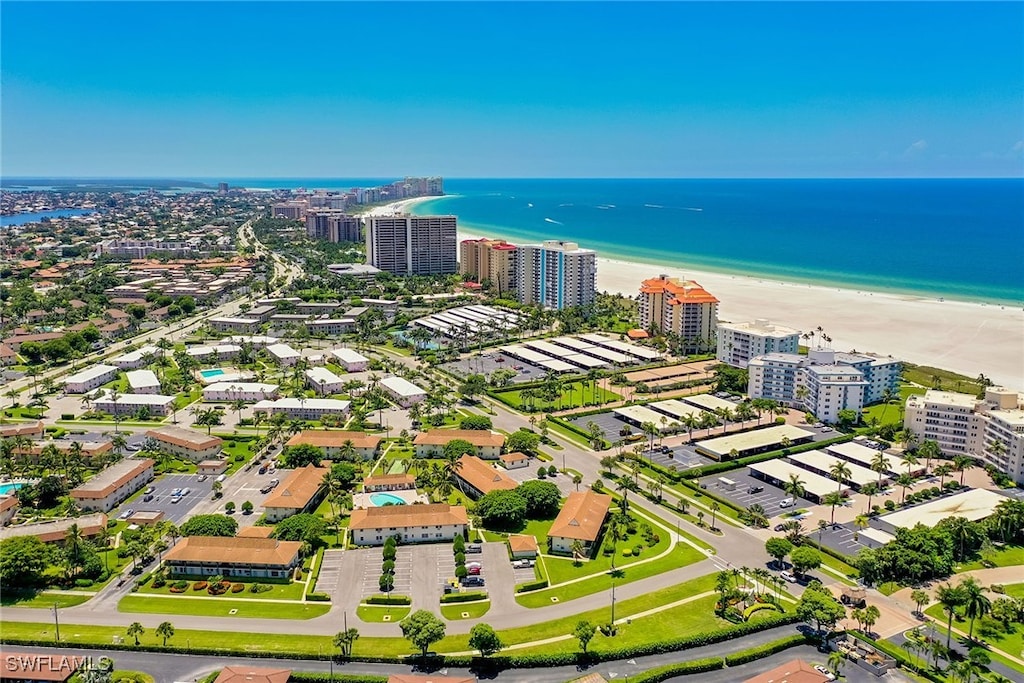 bird's eye view featuring a beach view and a water view