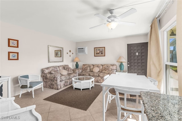 living room with ceiling fan, light tile patterned floors, and an AC wall unit