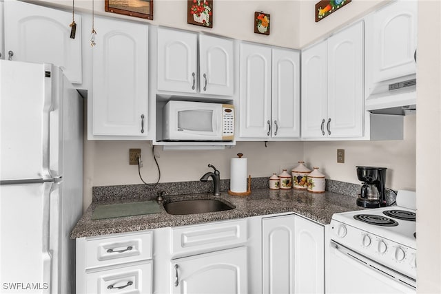 kitchen with white cabinetry, sink, dark stone counters, white appliances, and custom range hood