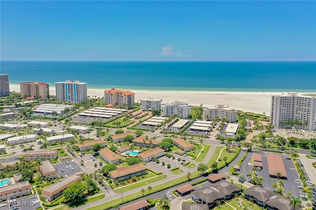 bird's eye view featuring a view of the beach and a water view