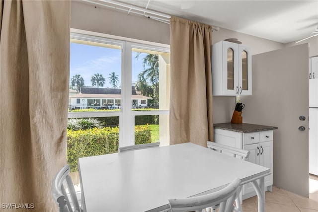 tiled dining room featuring ceiling fan