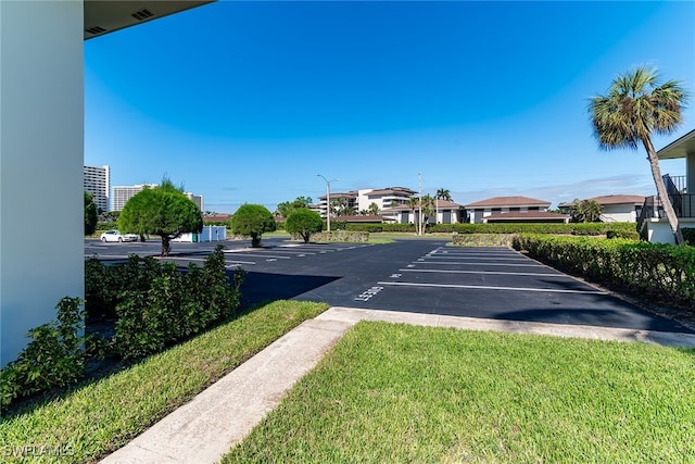 view of vehicle parking featuring a lawn